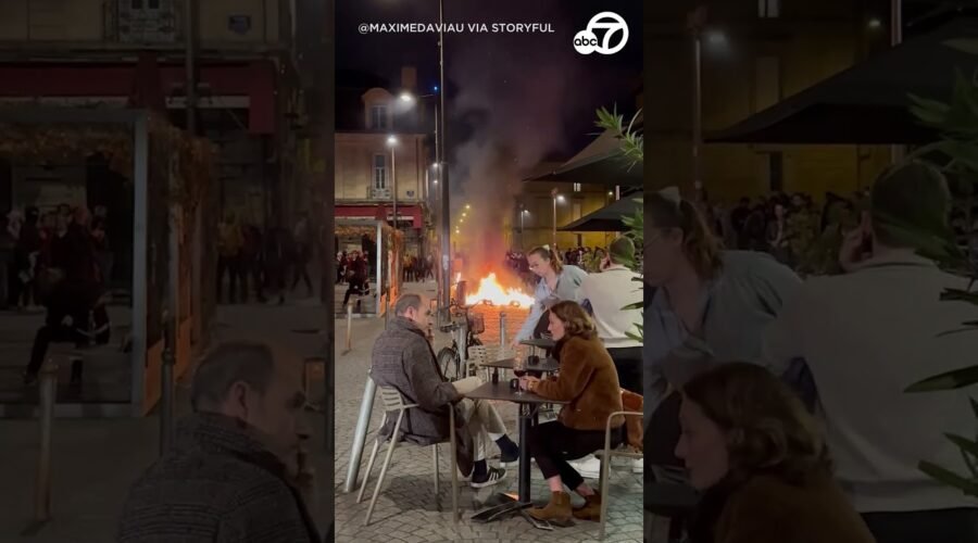 French diners sit with wine despite raging protest fire